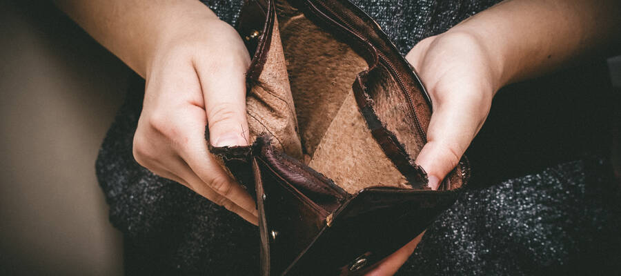 Old empty wallet in the hands .Vintage empty purse in hands of women . Poverty concept, Retirement. Special toning